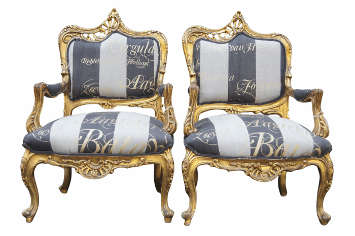 A Pair of 20th Century Circa 1940’s French Style Carved and Gilded Armchairs upholtered in a Custom and Hand-made French Linen with Gold Script Design