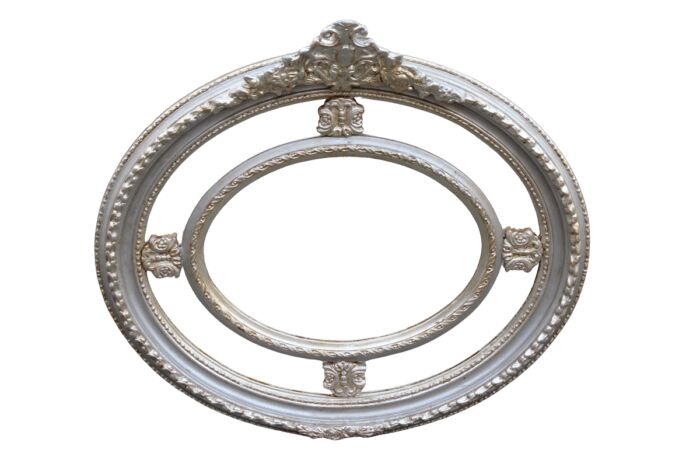 Ornate oval silver gilded mirror with crown