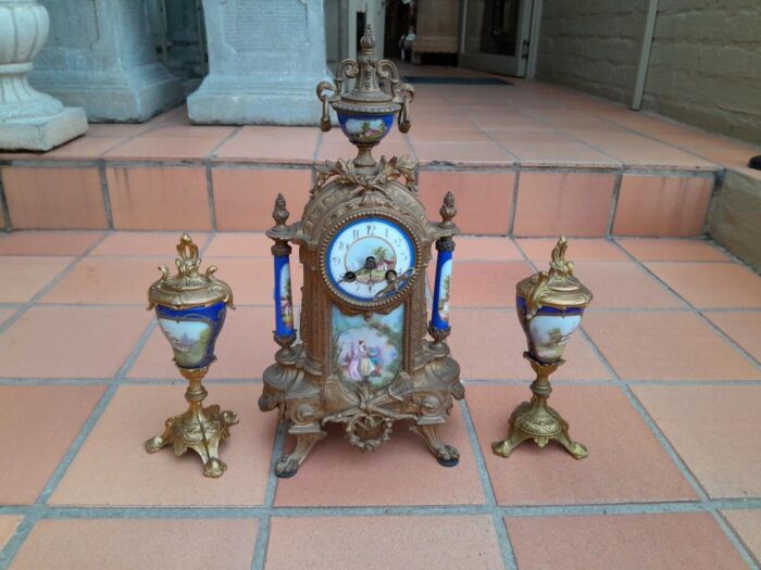 A 19th Century French Garniture Set With Gilt Bonze Clock With Key  And Pair Of Gilt Metal Porcelain Garniture On Velvet Bases - Image 2