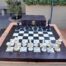 A 20th Century Hand Carved Ebony And Ivory Chess Set With Board And Leather Case