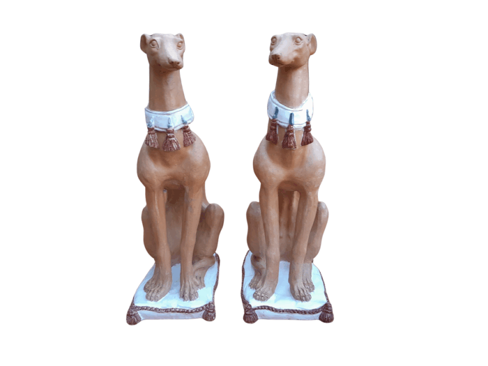 A 20th Century Pair Of Ceramic Whippets On Cushion Bases