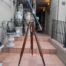 An Antique Brass And Leather Telescope On Brass And Oak Tripod Stand
