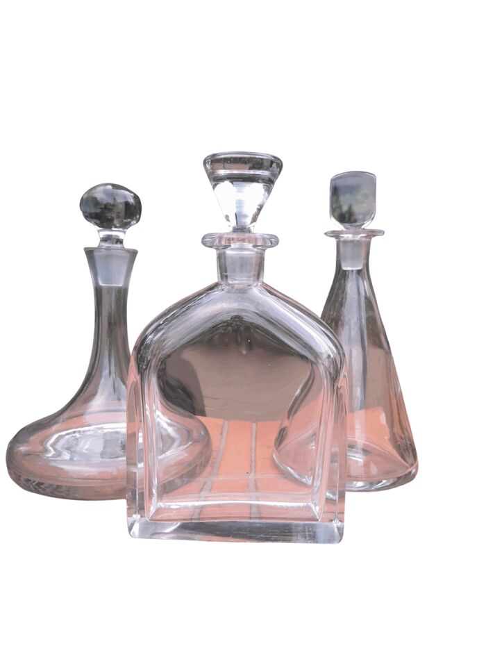 A Set of Three Glass Decanters