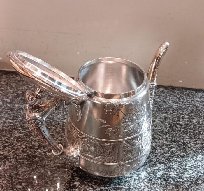A Silver-Plated Tea Pot With Floral Designs - Image 8