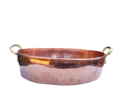 A Copper Pot With Brass Handles