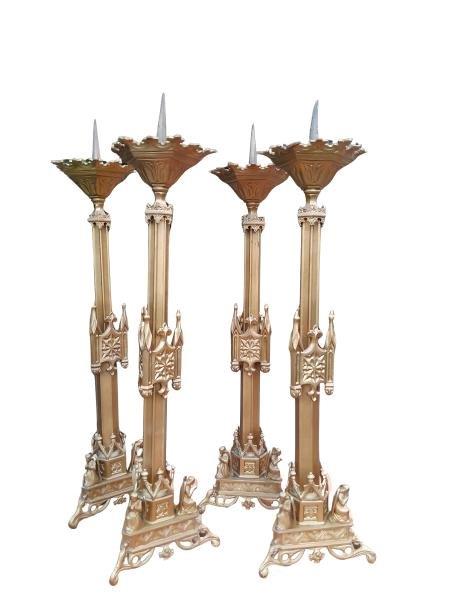 A Set Of Four Tall Renaissance Revival Brass Painted Alter Candle Sticks