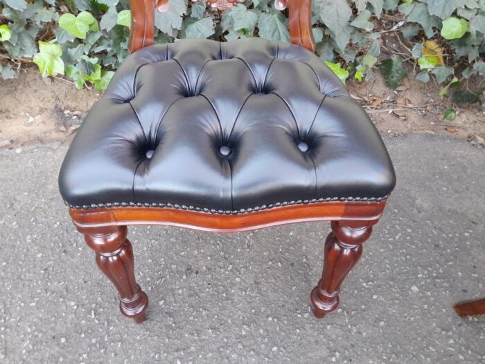 A 20th Century Set of Ten Teak Wood Bustle Back Chairs Upholstered in Deep Buttoned Leather - Image 5