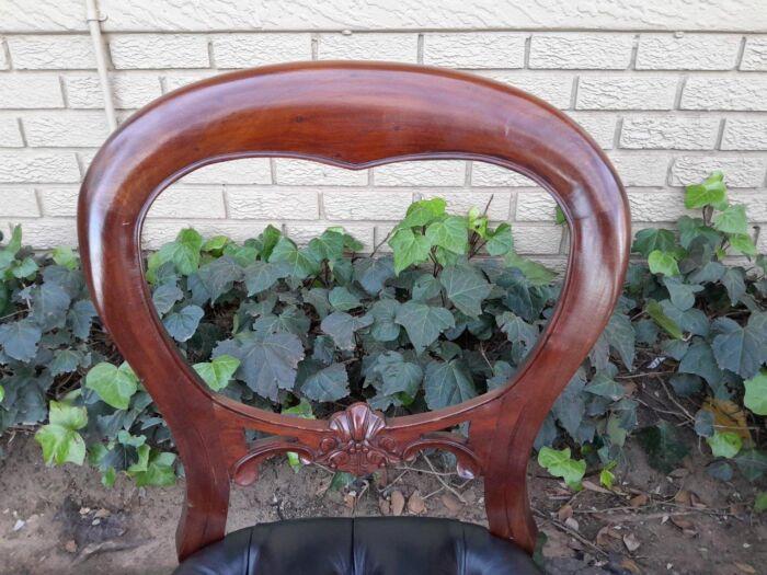 A 20th Century Set of Ten Teak Wood Bustle Back Chairs Upholstered in Deep Buttoned Leather - Image 6