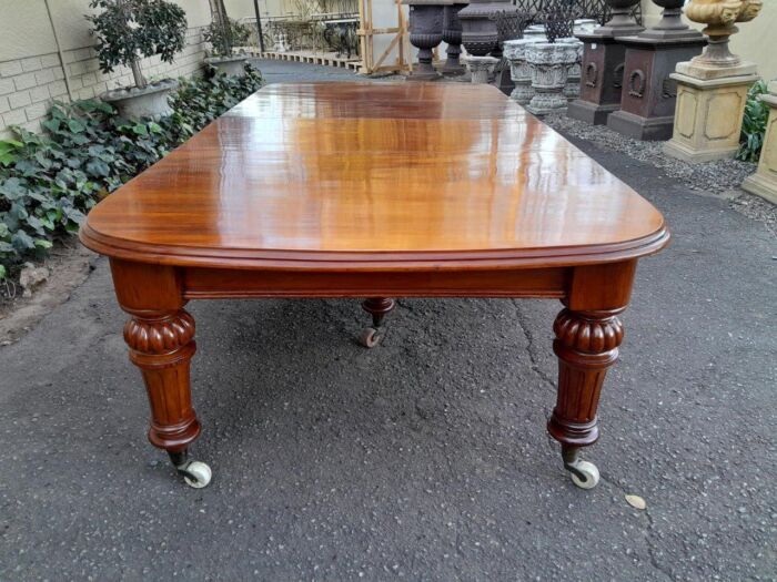 An Antique Victorian Oak Dining Table on Porcelain Castors with Two Leaves (10 Seater) - Image 4