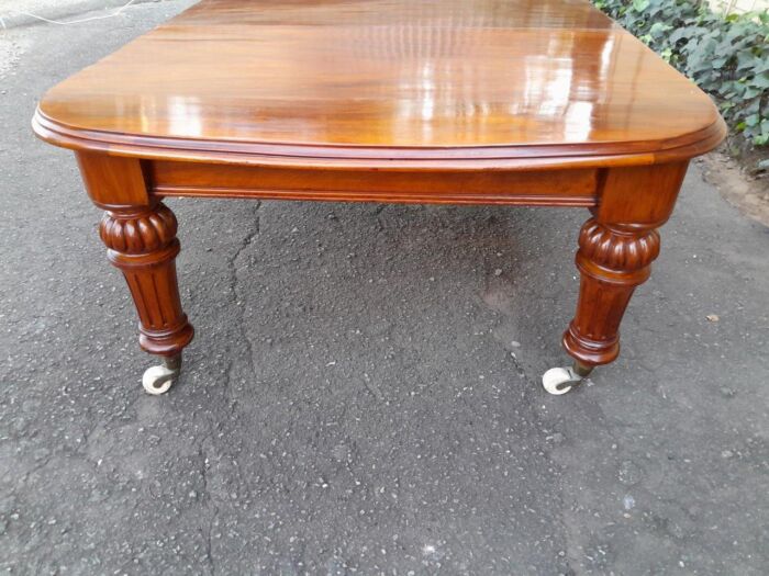 An Antique Victorian Oak Dining Table on Porcelain Castors with Two Leaves (10 Seater) - Image 6