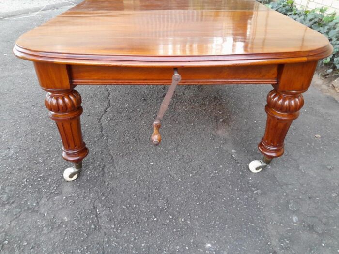 An Antique Victorian Oak Dining Table on Porcelain Castors with Two Leaves (10 Seater) - Image 7