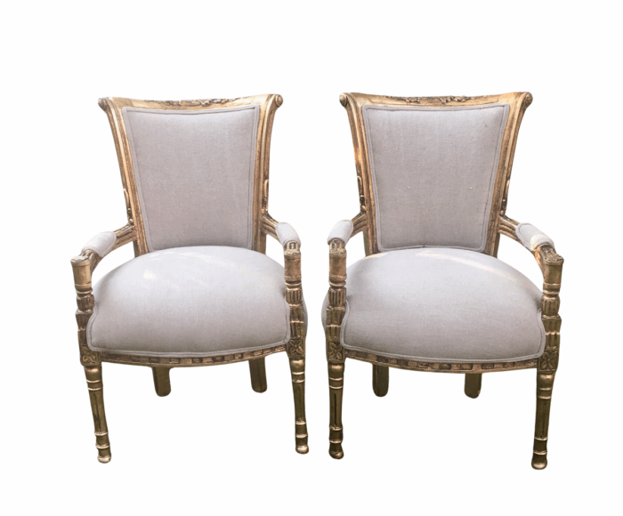 A Pair of French Style Arm Chairs, Hand-Gilded with Gold Leaf and Covered in an Imported Linen