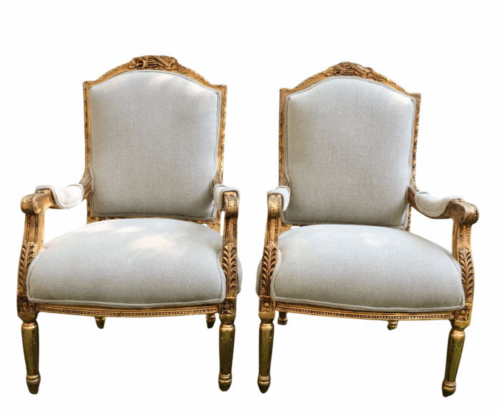 A Pair of French Louis XVI Styled Ornately carved and gilded Fautelli  Chairs in Linen Upholstery