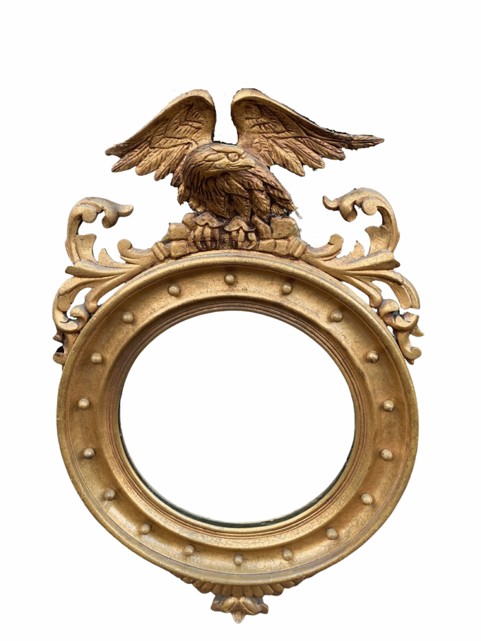 A circular framed 19thC style mirror with eagle crest