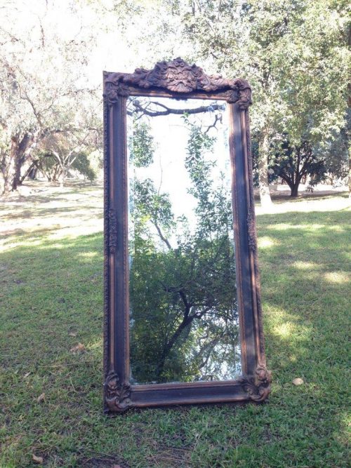 An Ornate Carved Bevelled Mirror
