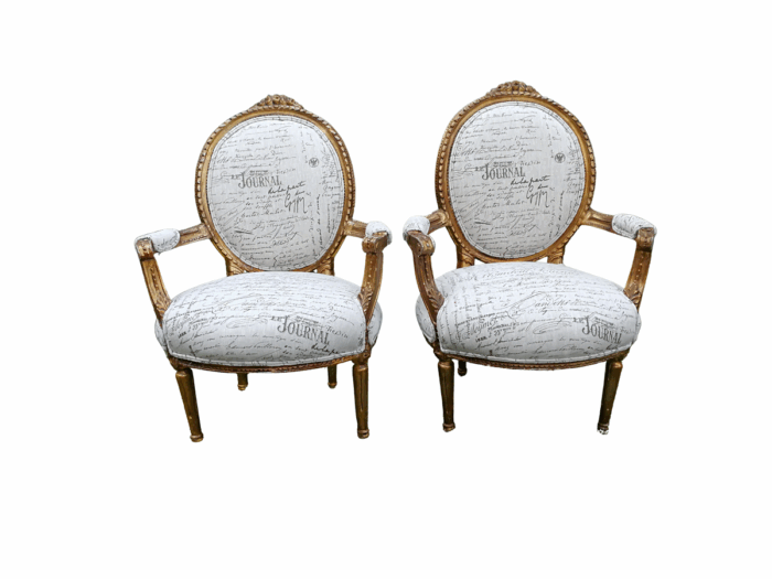 A Pair of French Style Carved and Gilded Armchairs Upholstered in a Custom-made Script on Linen Fabric for The Crown Collection