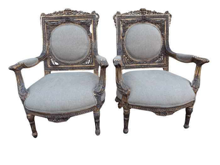 A 20th Century Pair (over 80 years old) of French Style Ornately Carved and Gilded Arm Chairs Upholstered in a French Linen ND