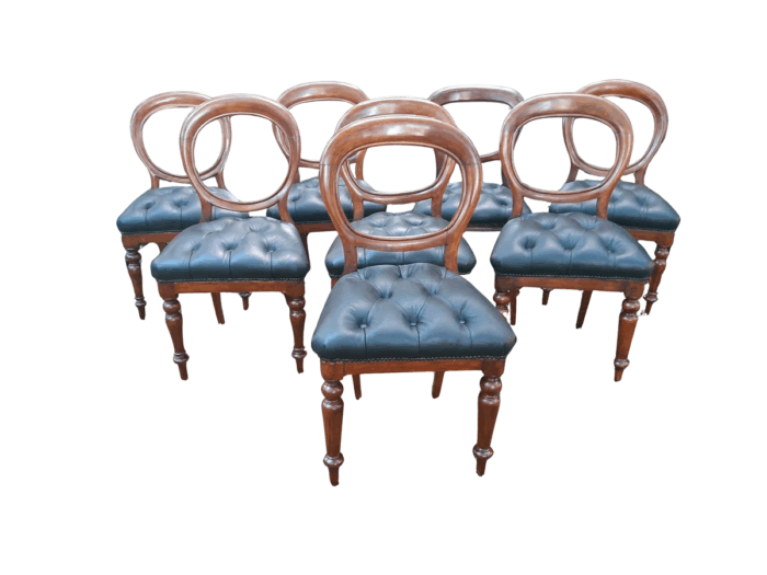 A 19th / Early 20th Century Victorian Set of Eight Bustle Back Dining Chairs Upholstered in a Deep Buttoned Leather