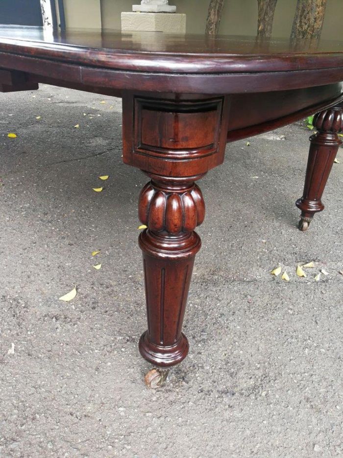 A three meter Victorian mahogany extending dining table on carved legs and castors, with four leaves and crank - Image 6