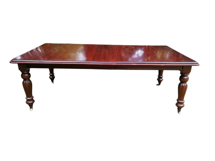A Victorian Style Mahogany extending ten-seater dining room table on brass castors and with winding crank (10 Seater)