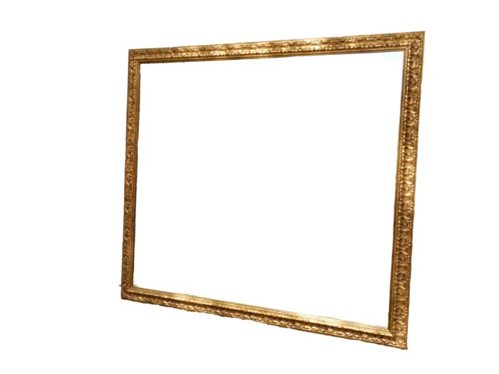 A large gilded mirror with ornate frame