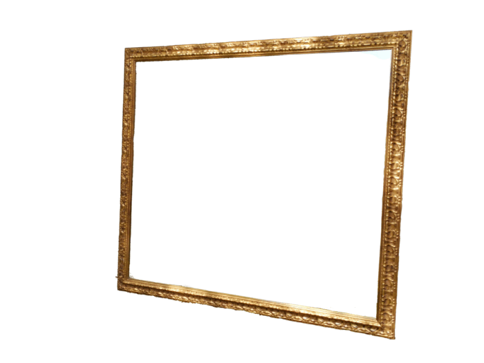 A large gilded mirror with ornate frame