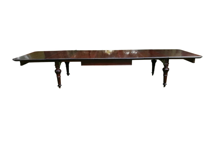 A Victorian Mahogany Fourteen To Sixteen Seater Dining Table / Refectory Table With Five Extension Leaves, On Brass Casters