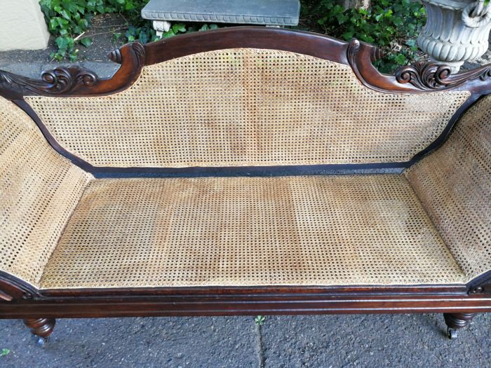 An Antique Victorian Carved Mahogany and Rattan Settee On Castors with Hessian Cushions and Bolsters - Image 11