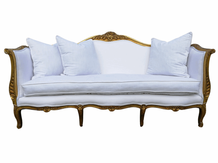 A French Louis XVl Style Gilded Settee Upholstered in a White Linen with Three Scatter Cushions