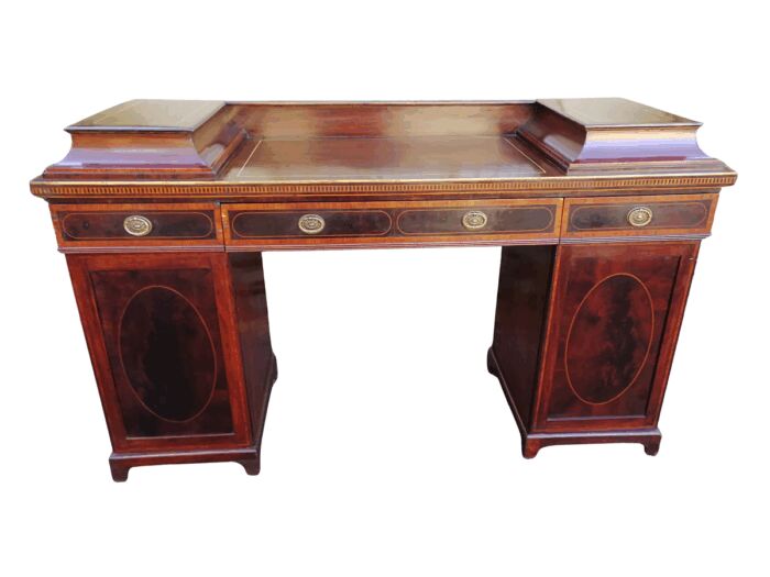A Late Regency Inlaid Mahogany and Rosewood Pedestal Sideboard, fitted with original oval foliate brass escutcheons and loop handles and with a cellarette drawer