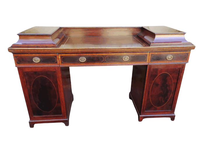 A Late Regency Inlaid Mahogany and Rosewood Pedestal Sideboard, fitted with original oval foliate brass escutcheons and loop handles and with a cellarette drawer