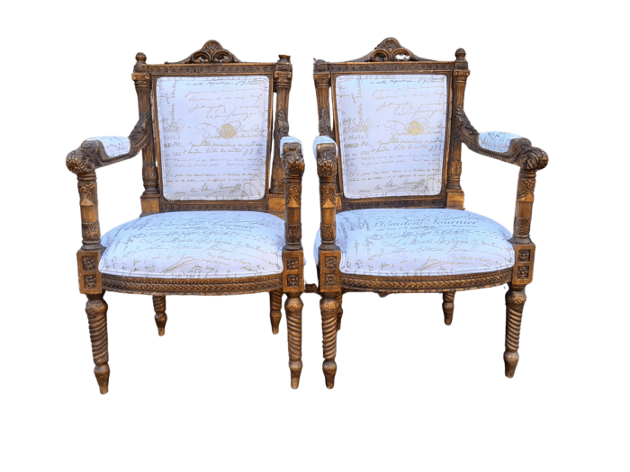 A Pair of 20th Century French Style Carved and Hand Gilded Armchairs Upholstered in a Custom and Handmade Gold Script Linen for The Crown Collection