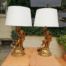 A Pair of Gilded Composite Cherub Table Lamps