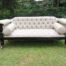 A 20thcentury English Rosewood Settee On Castors And Upholstered In Black Leather And Deep Buttoned 