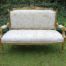 A French Style Hand-Gilded Beechwood Settee Upholstered In A Custom-Made Handmade Linen With Script Design