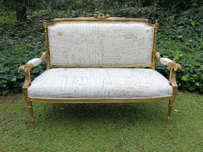 A French Style Hand-Gilded Beechwood Settee Upholstered In A Custom-Made Handmade Linen With Script Design