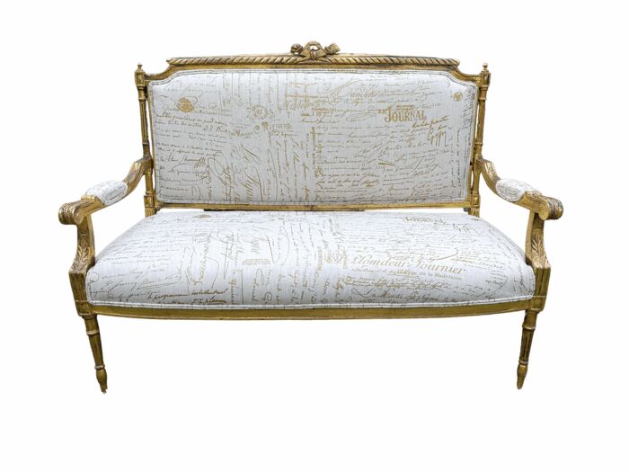 A French Style Hand-Gilded Beechwood Settee Upholstered In A Custom-Made Handmade Linen With Script Design