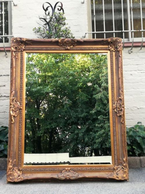A Large Hand Gilded Frame And Bevelled Mirror
