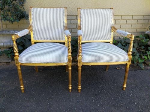 A Pair Of Carved And Gilded Armchairs
