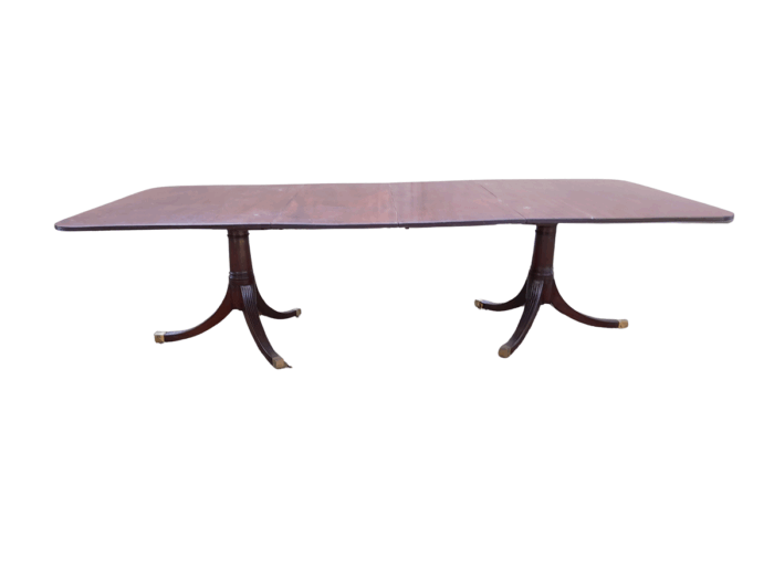 A 20th Century Mahogany Dining Table with Two Extensions and Brass Feet & Casters