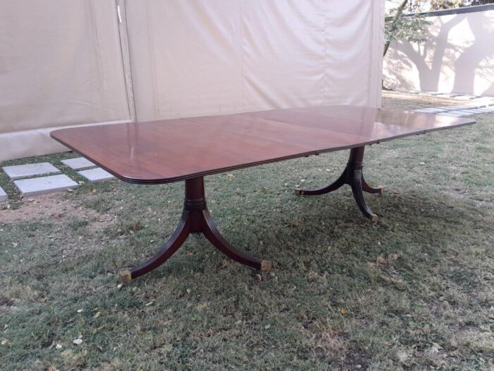 A 20th Century Mahogany Dining Table with Two Extensions and Brass Feet & Casters - Image 9