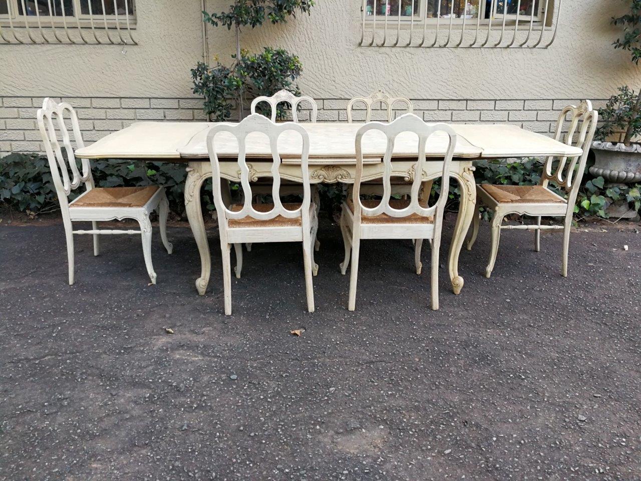 A French Parquetry Wooden Extending Dining Table with Two leaves and a Set of Six Dining Chairs with Rush Seats in a Bleached Contemporary Finish