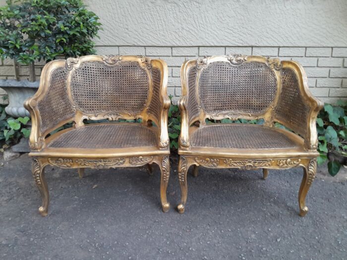 A 20th Century Pair or French Bergere Style Carved and Hand Gilded in Gold Leaf Wooden Chairs - Image 2