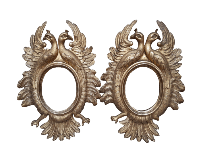 A 20th Century Pair Of Carved Mirrors With Stylised Bird Design