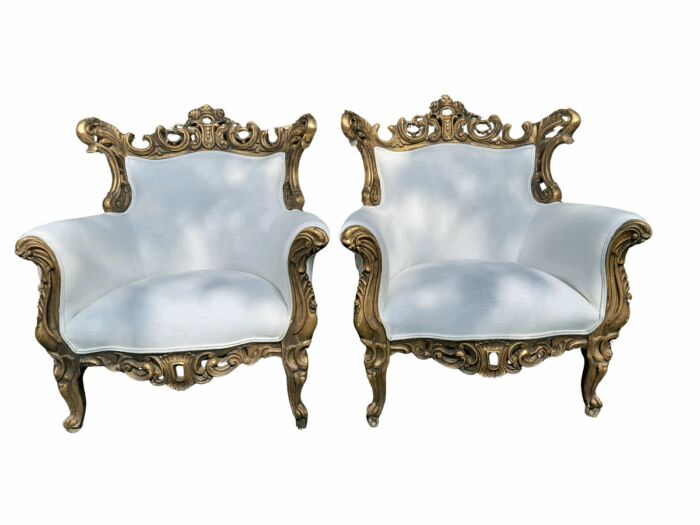 A French Style Pair of Ornately Carved Gilt Wood Armchairs