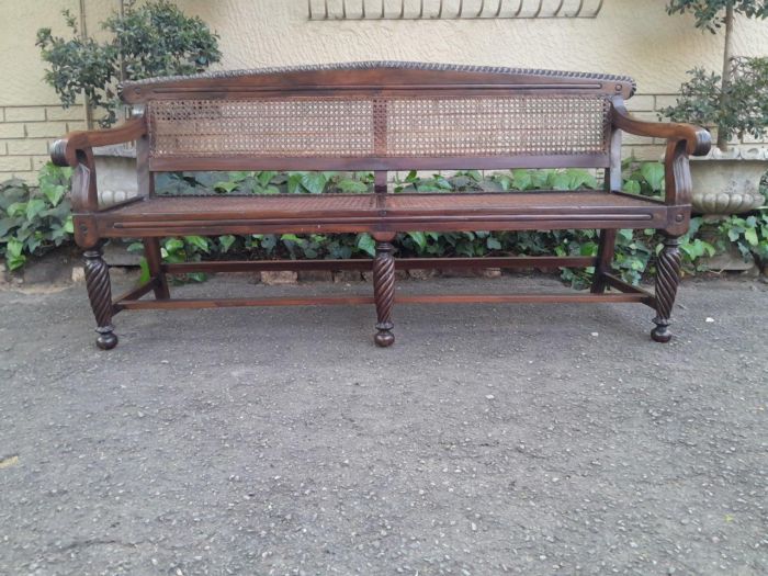 An Early 19th Century Rosewood Colonial Carved Bench with New Rattan in an Ebonised Finish