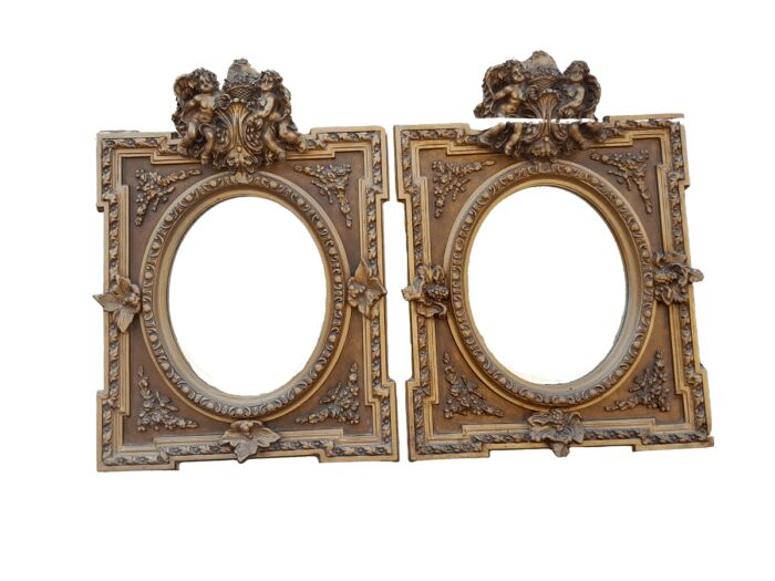 An Exceptional Pair of 20th Century French Style Ornately Carved and Gilded Bevelled Mirrors with Cherubs