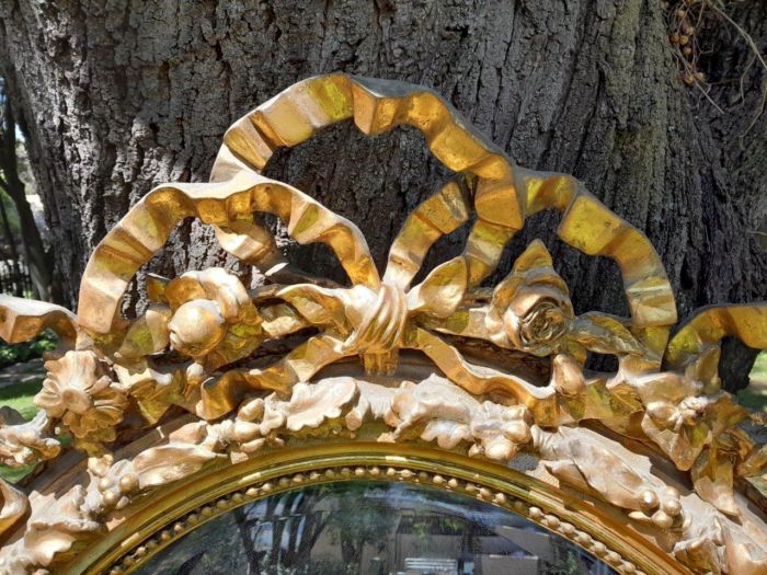 A French Rococo Style Ornately Carved and Gilded Oval Bevelled Mirror - Image 6