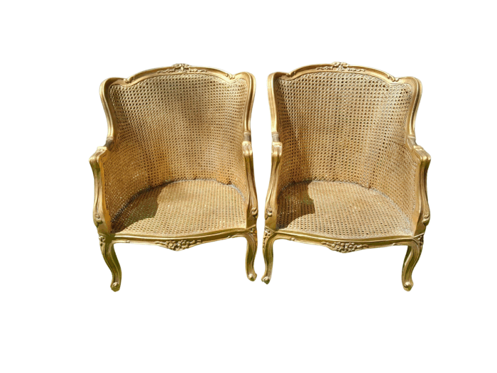 A 20th Century Pair of French Style Rattan Hand Gilded Wing Back Chairs