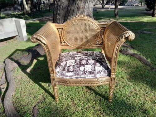 A 20TH Century French Style Carved Ornate Rattan Arm Chair